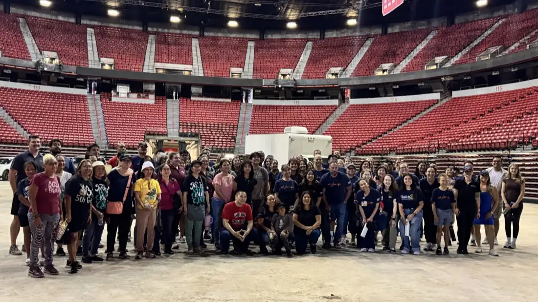 Volunteers gathered on the arena floor at Pack the Mack 2026.