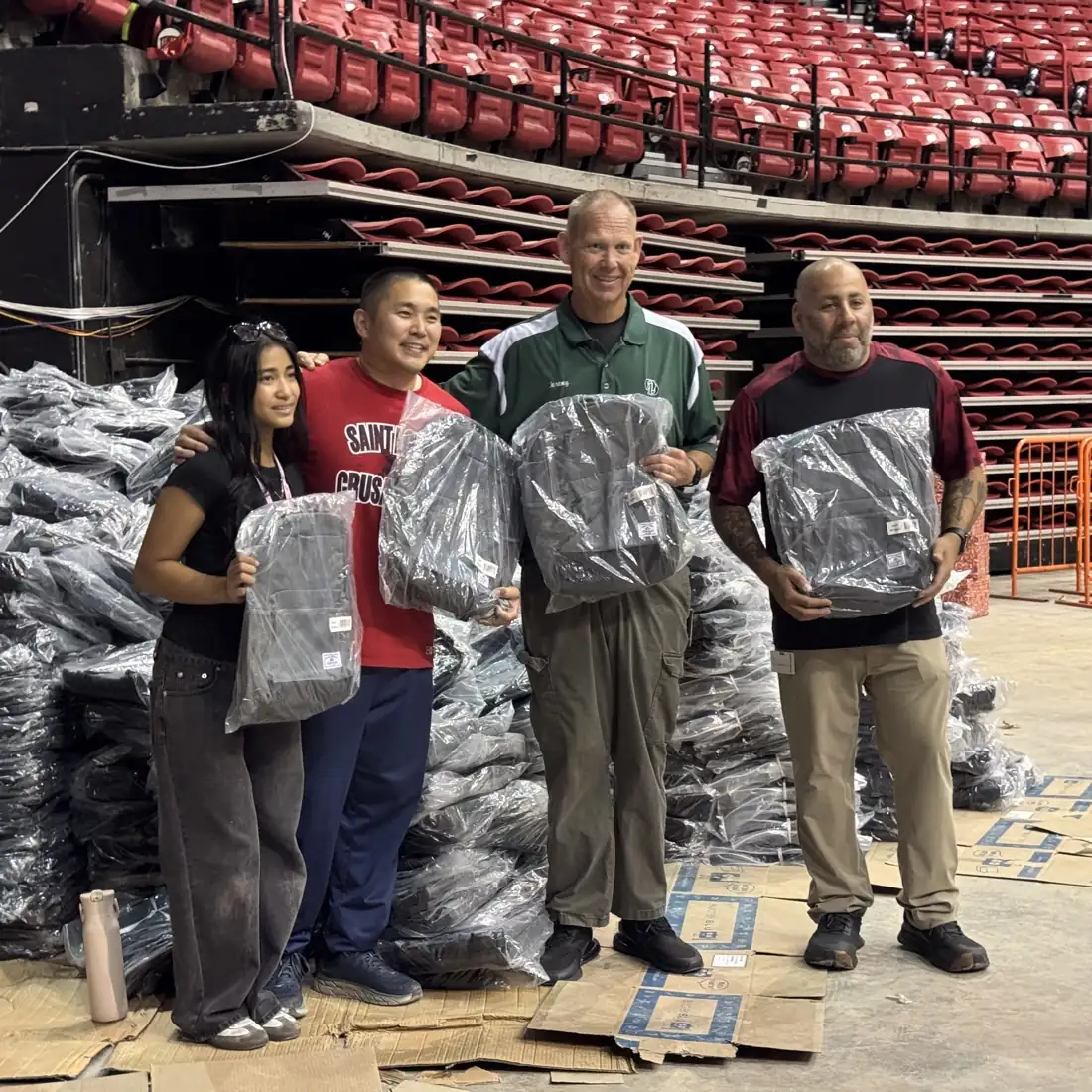 Volunteers preparing backpacks at the Thomas & Mack Center.