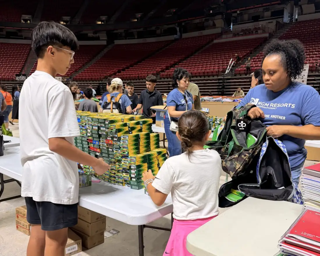 School supplies sorted into backpacks for students.
